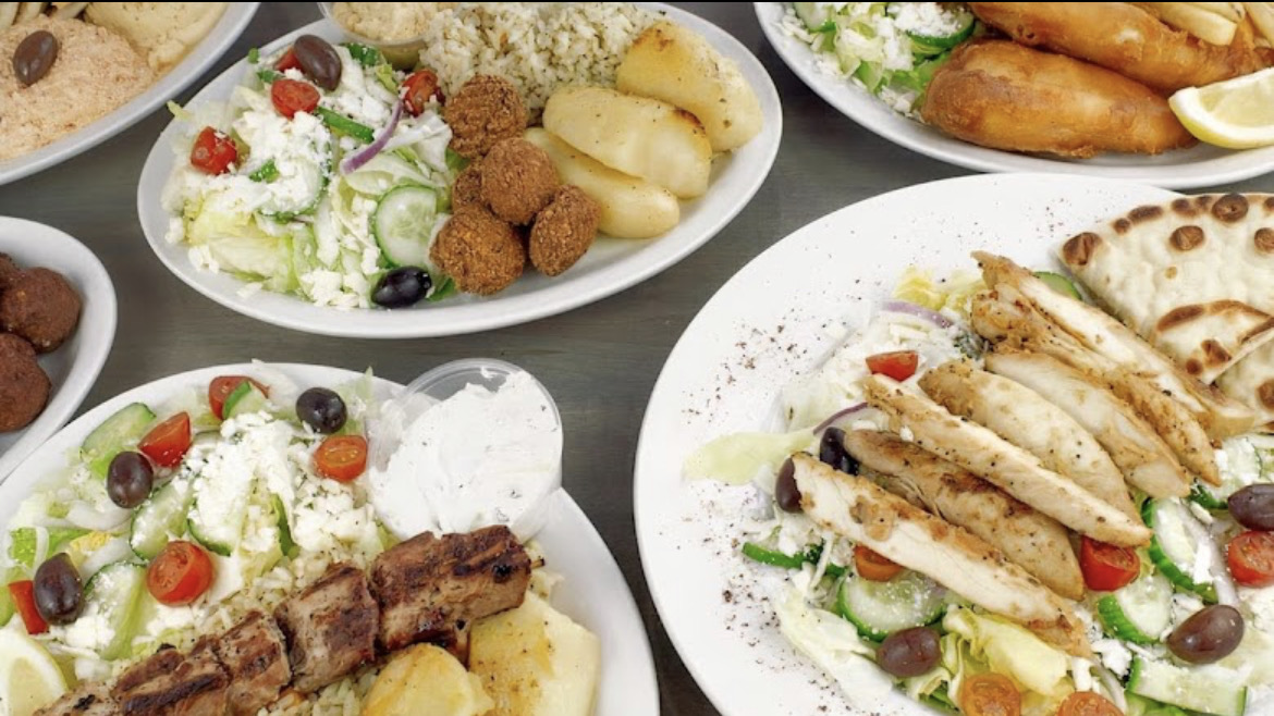 Fresh Greek food being plated in the Little Gyros kitchen